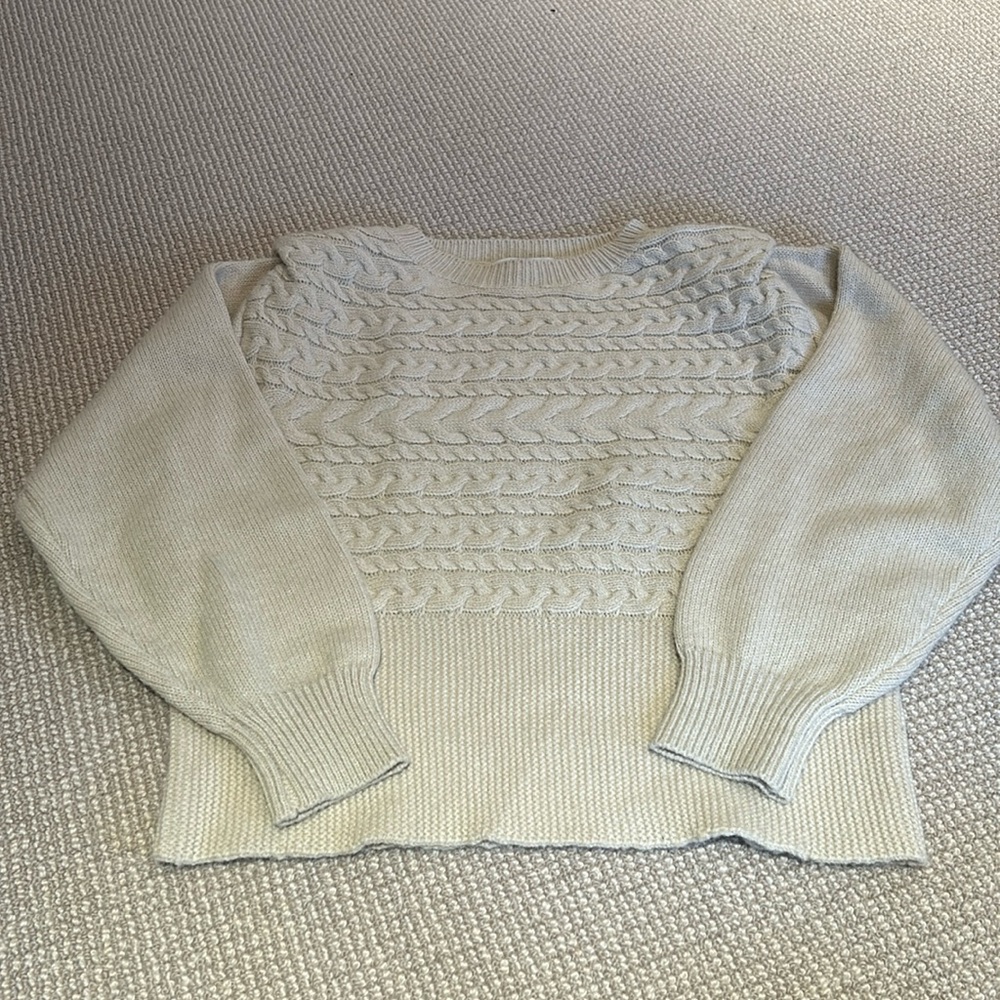 Knit sweater with padded shoulders.